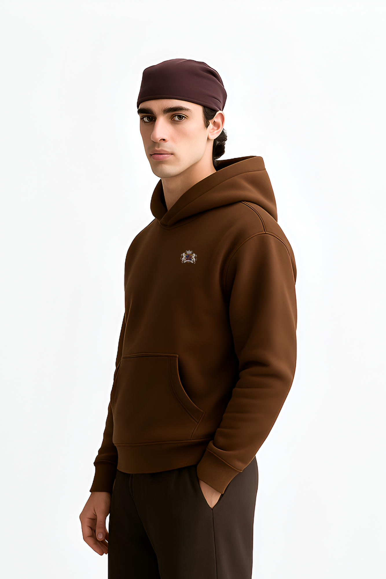 Person wearing a brown hoodie and pants with a white background